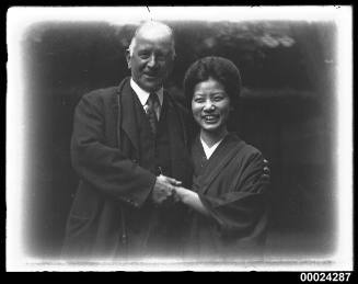 Portrait of a man with a woman in a kimono style dress possibly in Nagoya, Japan