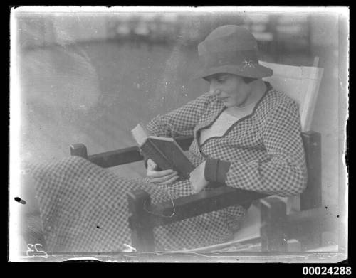 Portrait of a woman seated and reading possibly on board SS TANDA