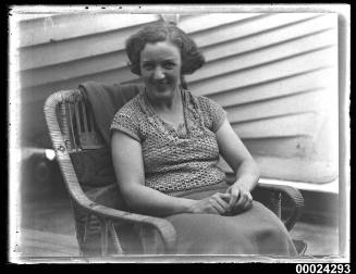 Portrait of a woman seated in a cane chair possibly on board SS TANDA
