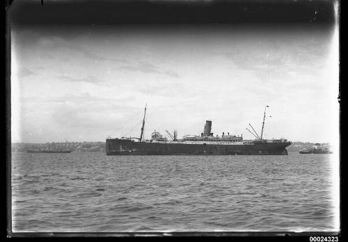 Portside view of a two-masted ship at anchor in a harbour