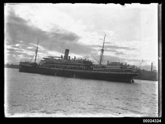 Portside view of a two-masted passenger ship in a harbour