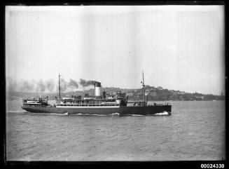 Starboard view of a passenger ship under steam in a harbour