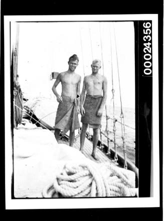 Harold Jnr and Richard Nossiter wrapped in towels on deck