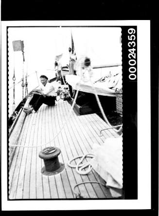 Harold Nossiter Snr sitting on the deck of yacht SIRIUS