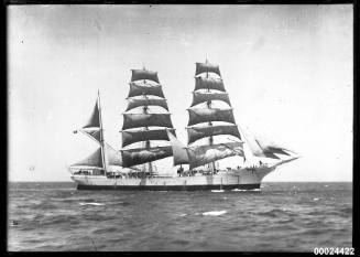 Starboard view of a three-masted barque underway at sea