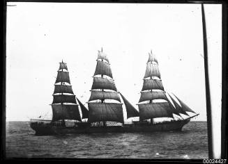 Starboard view of a three-masted ship underway at sea