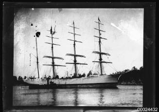 Starboard view of a four-masted barque anchored in a harbour