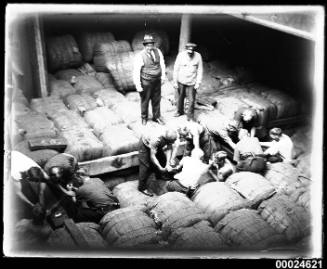 Loading wool into hold of MAGDELENE VINNEN