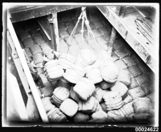 Bales of wool being lowered into the hold of MAGDALENE VINNEN