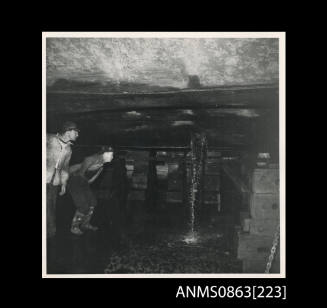 Two men examining KANIMBLA in dry dock