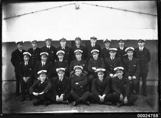 Group portrait of ships officers in three rows.