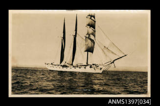 Photograph depicting a three masted vessel at sea