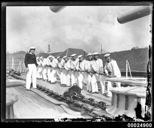 German naval sailors pulling on a rope, tug o' war style, on aft deck of KOLN