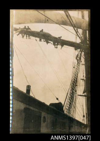 Photograph depicting a group of men on the ship's yard