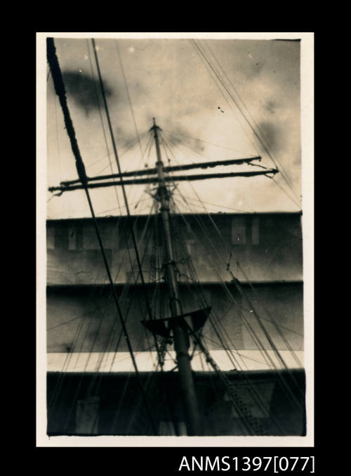 Photograph depicting the main mast of a ship in full sail