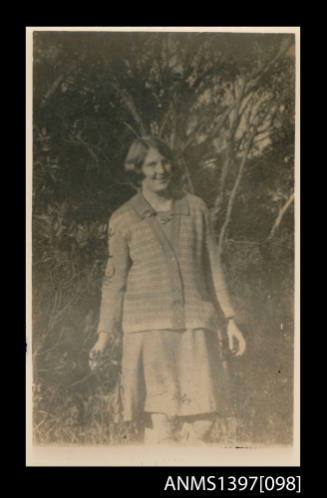 Postcard depicting  a woman posing for the camera