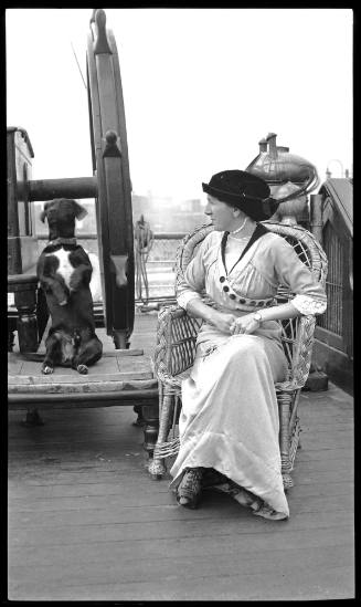 Unidentified woman and dog on the deck of a vessel