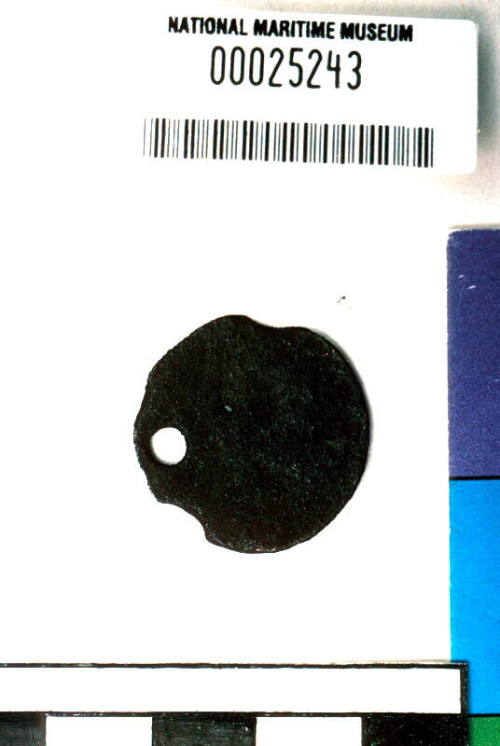 Pierced corroded coin