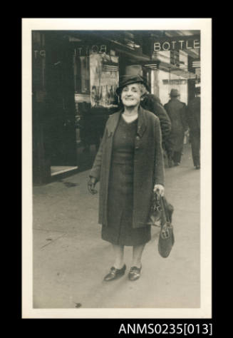 Muriel Binney standing outside a bottleshop in Sydney