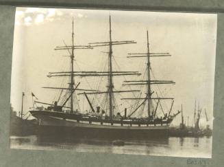 Full-rigged ship at a wharf