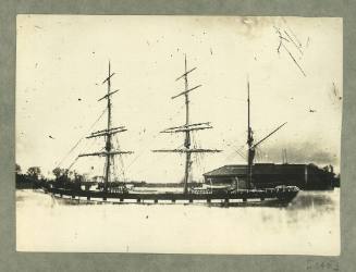 Full-rigged ship at a wharf