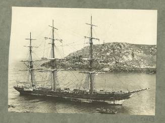 Full-rigged ship in a narrow rocky channel