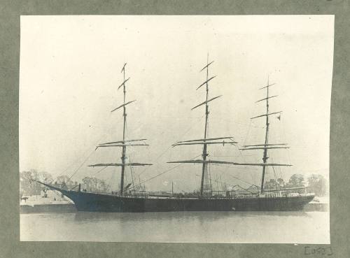 Full-rigged ship at a wharf