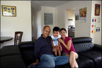 Mo Lu, his wife Lan Le and son Caleb at home in Goodna, Queensland