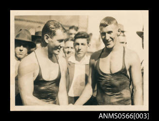 Two men shaking hands after a swimming race