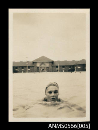 Photograph depicting a man training in a pool