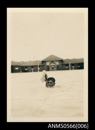 Photograph depicting a man swim training in a pool