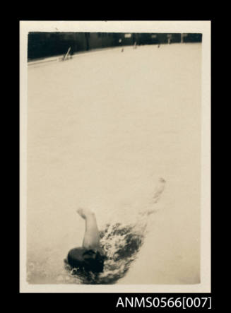 Photograph depicting a man swim training in a pool