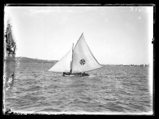 Gaff-rigged skiff with Maltese Cross insignia, possibly MAVIS heads north-east across Rose Bay on Sydney Harbour