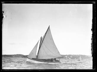 Gaff-rigged sloop sails possibly on Pittwater with four crew, skipper in suit coat