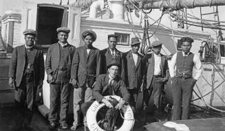 Crew members with dog on the missionary ship GILBERT ISLANDS