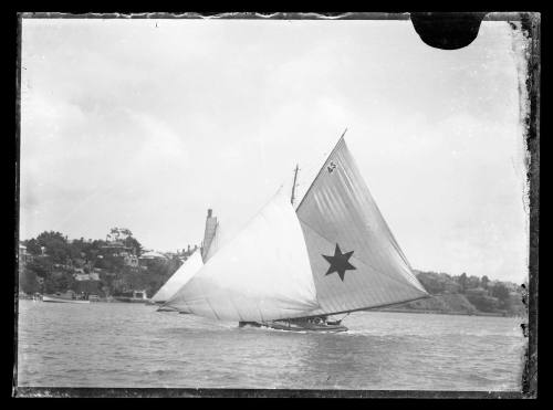 Two 18-foot skiffs racing on Sydney Harbour