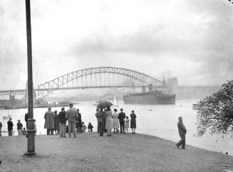 A vessel, possibly RMS MAURETANIA, near the Sydney Harbour Bridge