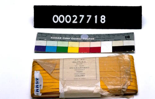 A bundle of yellow braid part of a tailor's kit