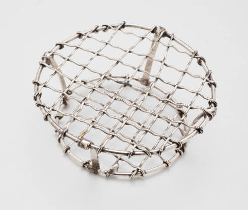 Wire mesh insert for a silver plated flower bowl