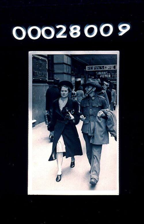 Leonard Pollard in army uniform walking down a Sydney city street with his fiance Joan Pennings