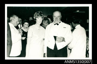 Captain Dun and an unidentified woman at a cocktail party onboard SS ARAMAC