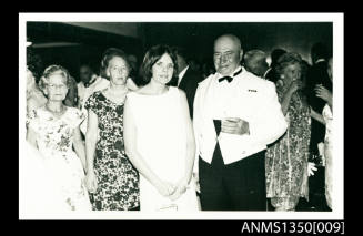 Captain Dun and unidentified female passengers at a cocktail party on SS ARAMAC