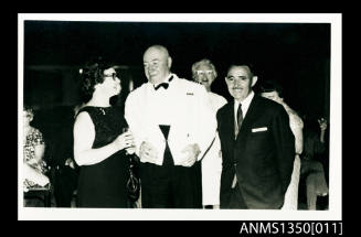 Captain Dun and a male and female passenger at a cocktail party onboard SS ARAMAC