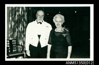 Captain Dun and an unidentified woman at a cocktail party onboard SS ARAMAC