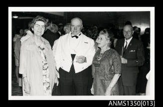 Captain Dun and unidentified passengers at a cocktail party onboard SS ARAMAC