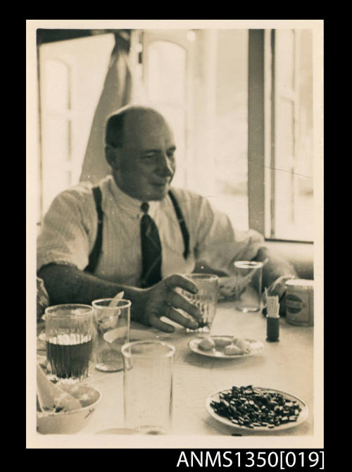 Image of a Captain Dun sitting at a table