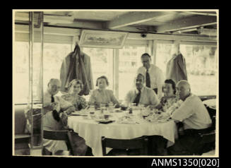 Image of people sitting around a table onboard a vessel