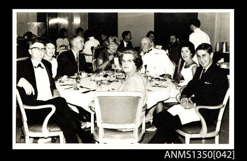 Image of group of people seated at a dining table including Captain Dun