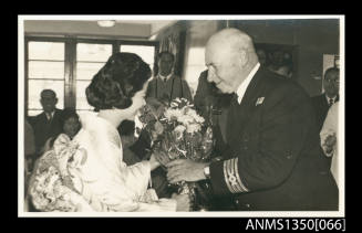 Captain Dun receiving a bunch of flowers