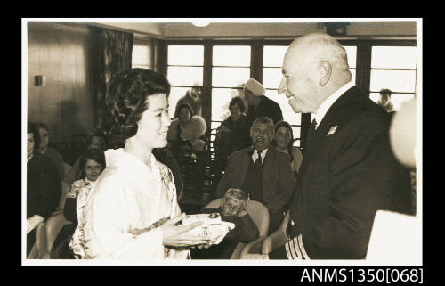 Captain Dun speaking to unidentified Japanese woman